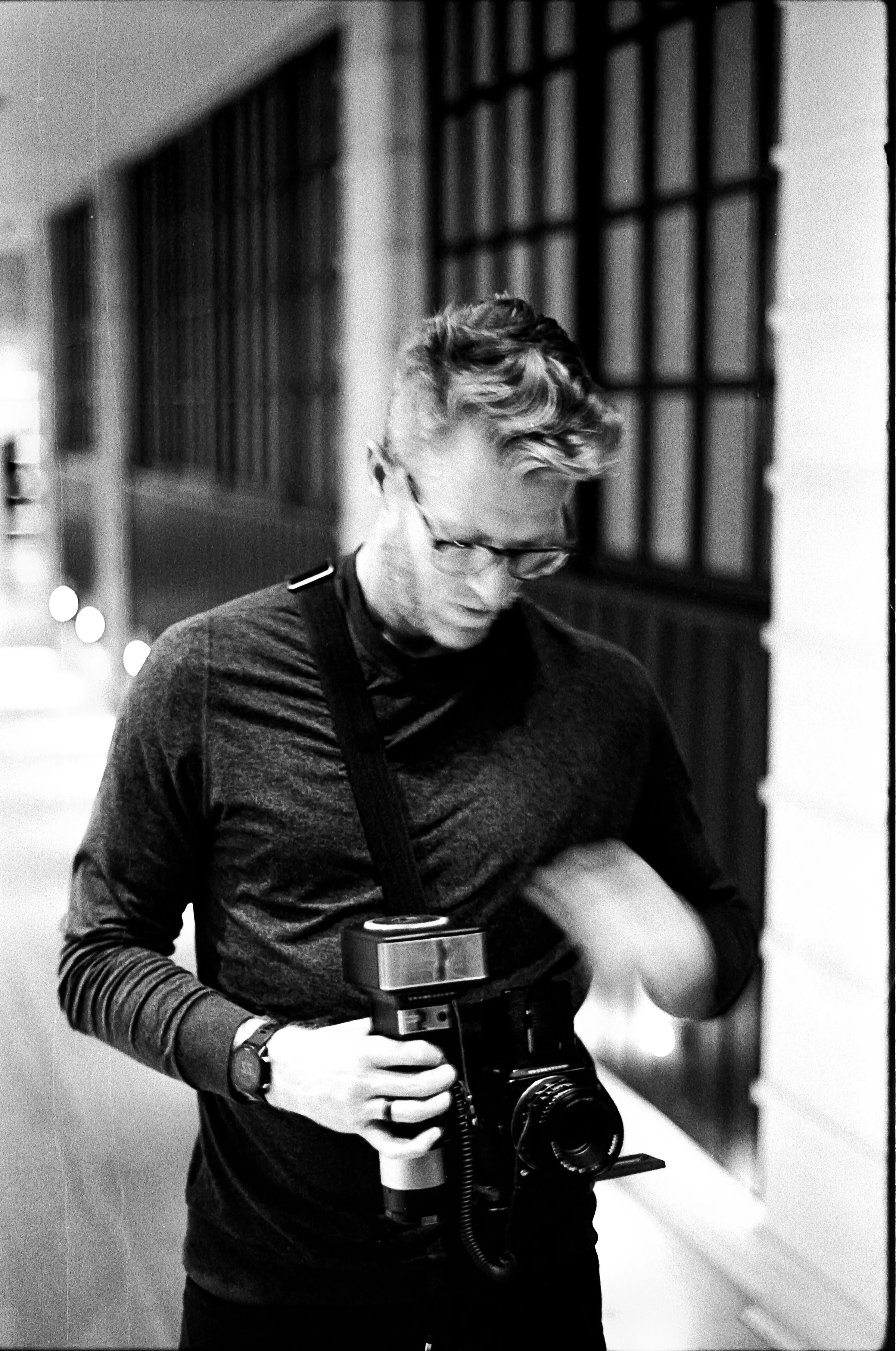 Black and white self portrait of Cody Strate with a Hasselblad medium format camera