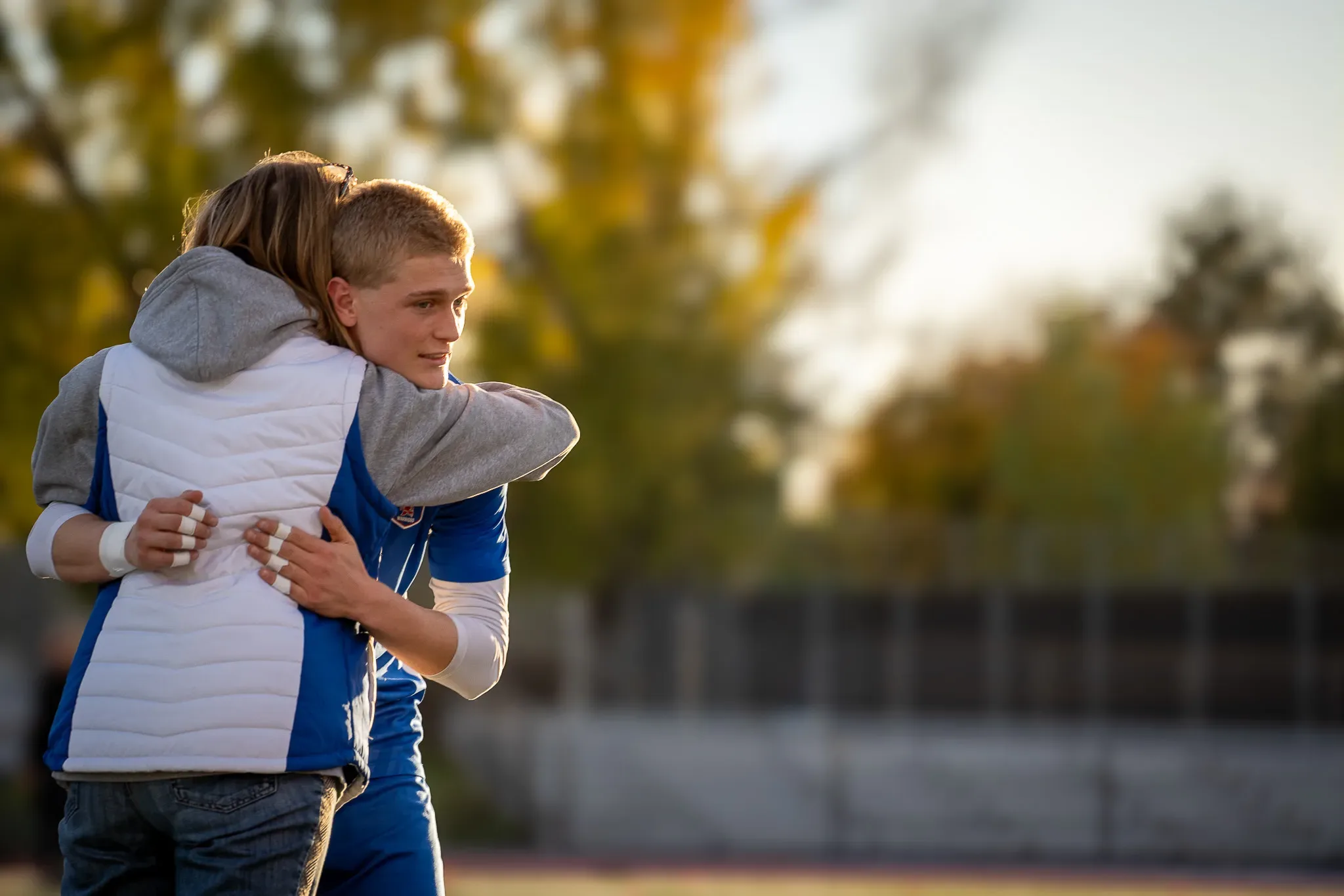 A Centaurus senior player hugging a family member on senior night